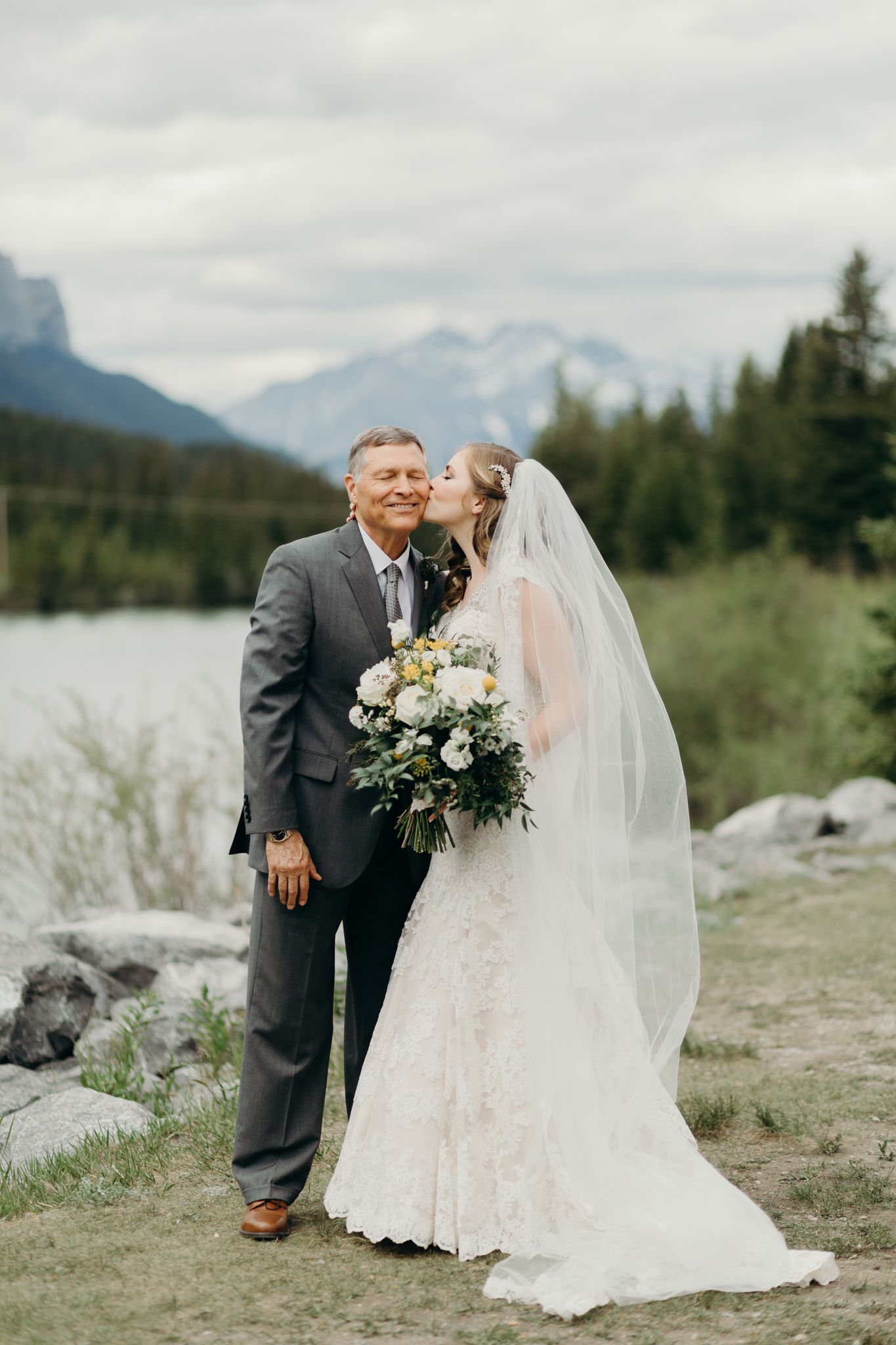 Bride and Father of bride pose by river smiling destination wedding photographer MN