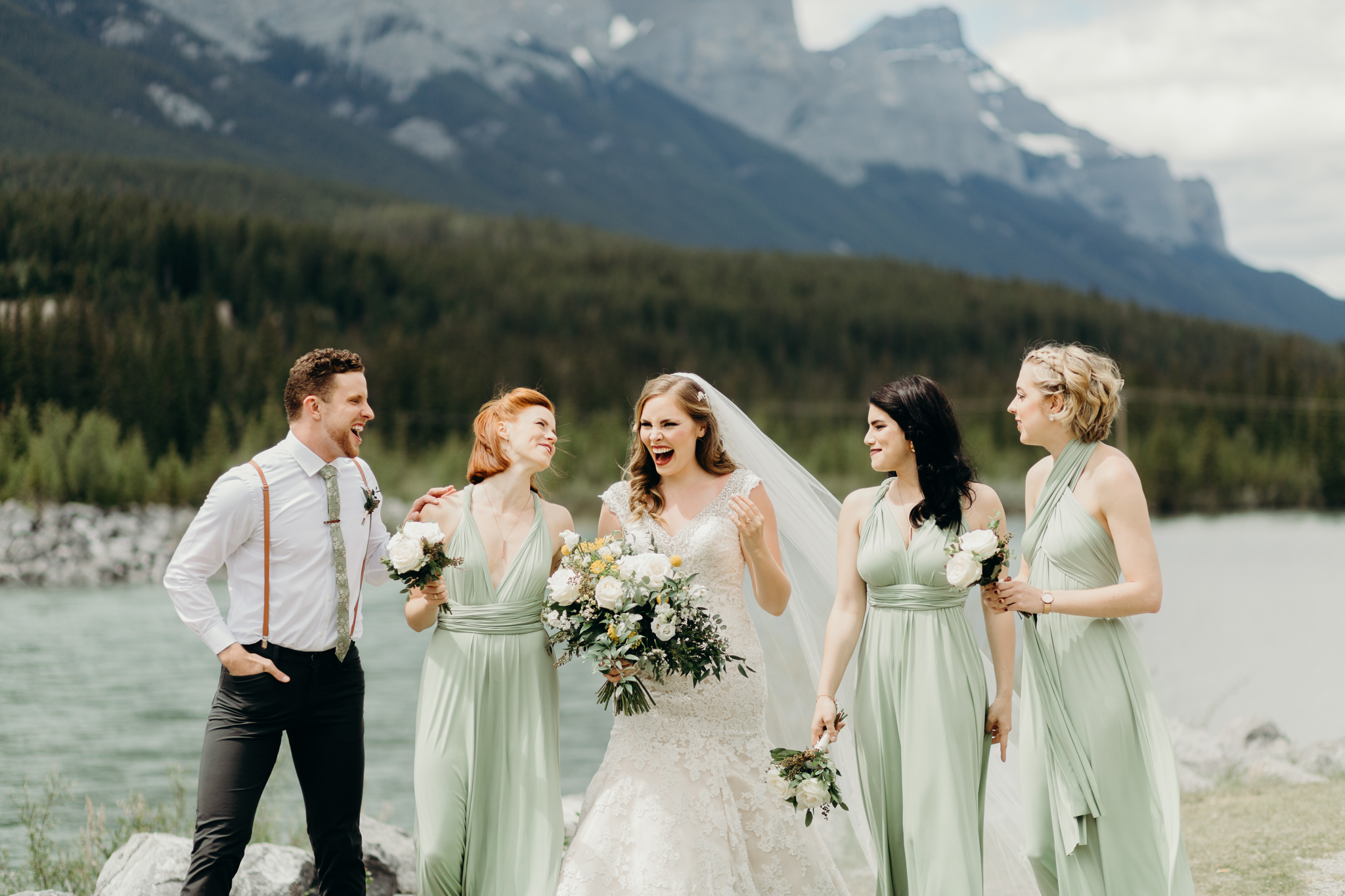 Bride and bridesmaids walk and laugh destination wedding photographer rocky mountains