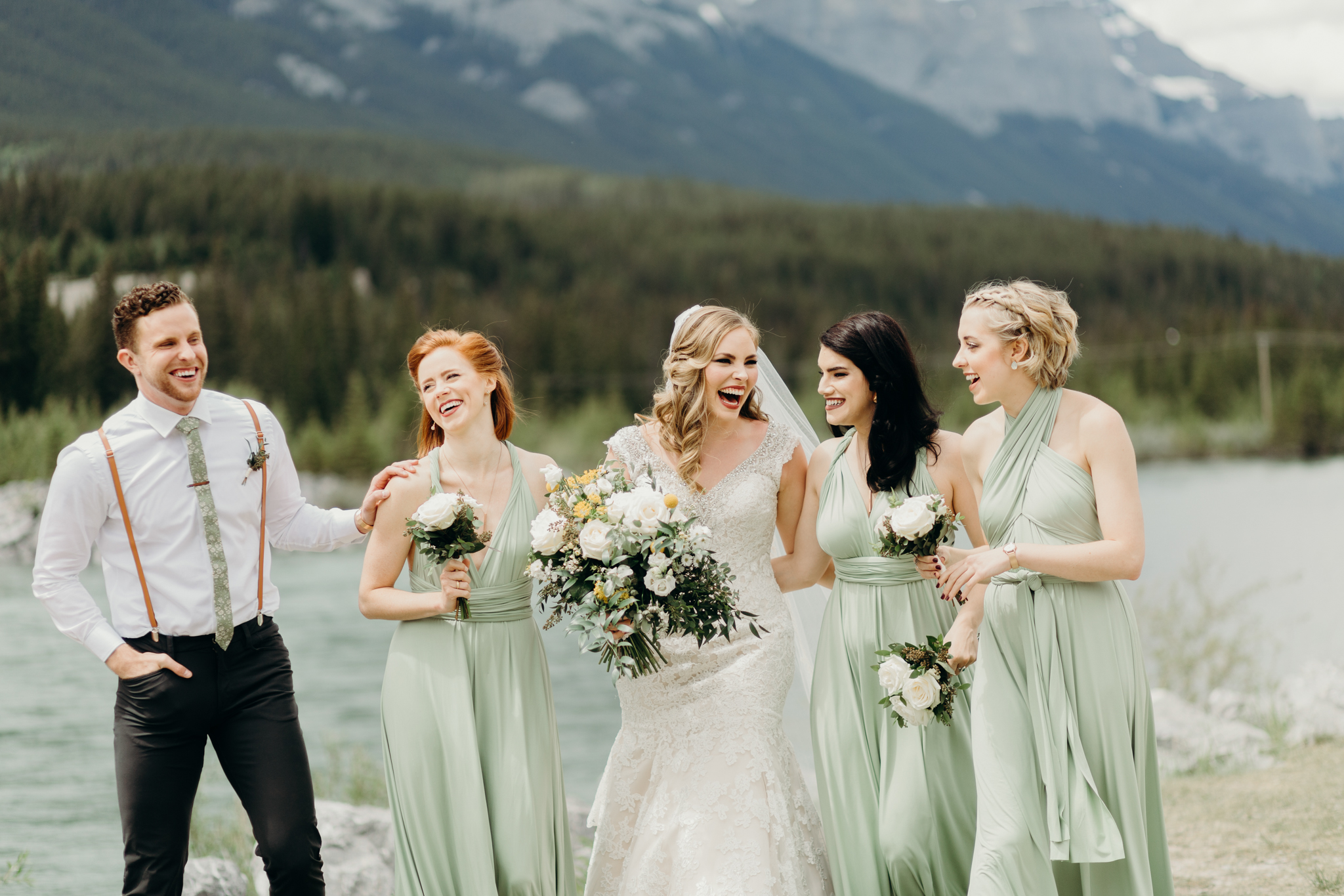 Bride and bridesmaids walk and laugh destination wedding photographer rocky mountains