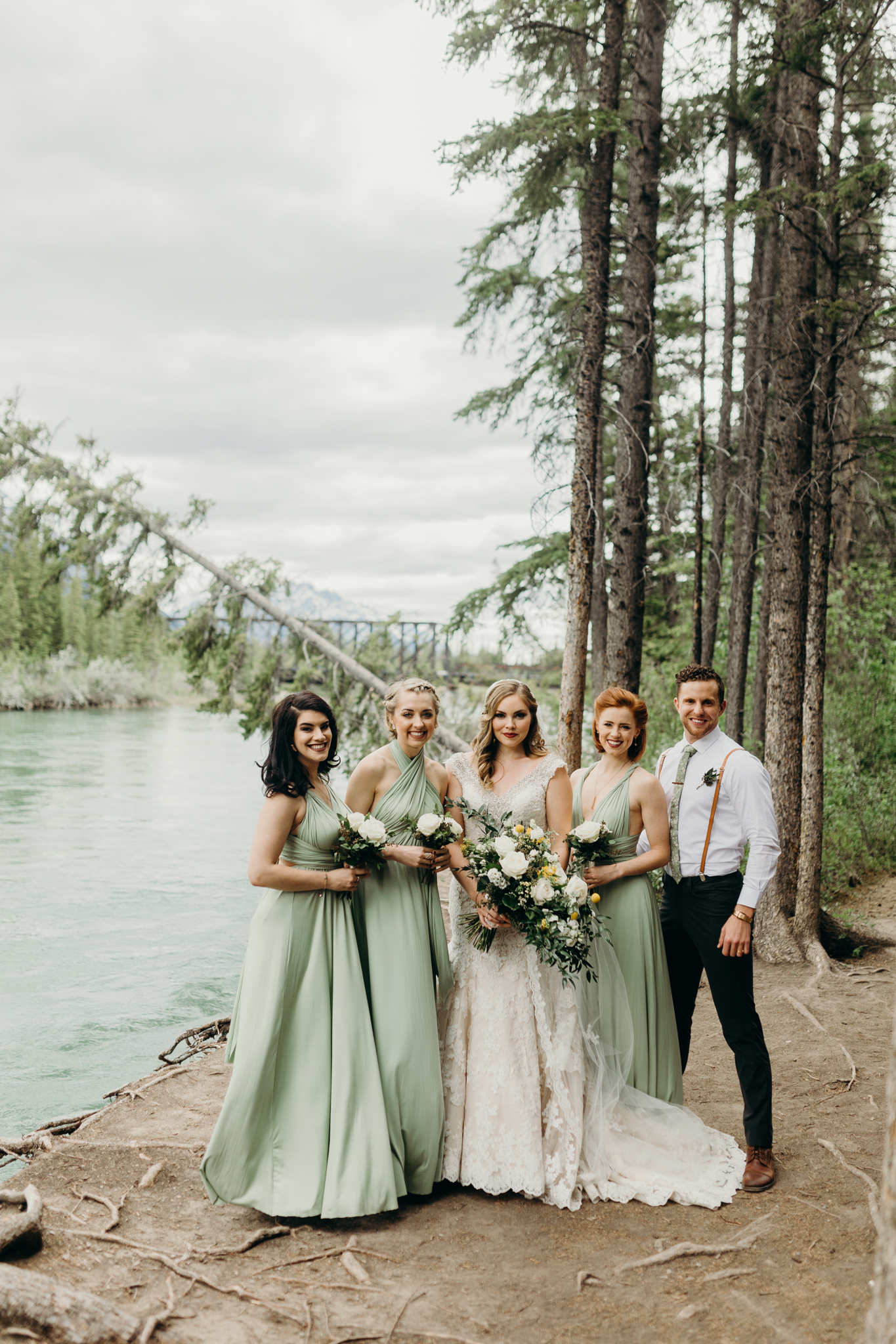 Brides and bridesmaids portrait at Bow River Canmore destination wedding