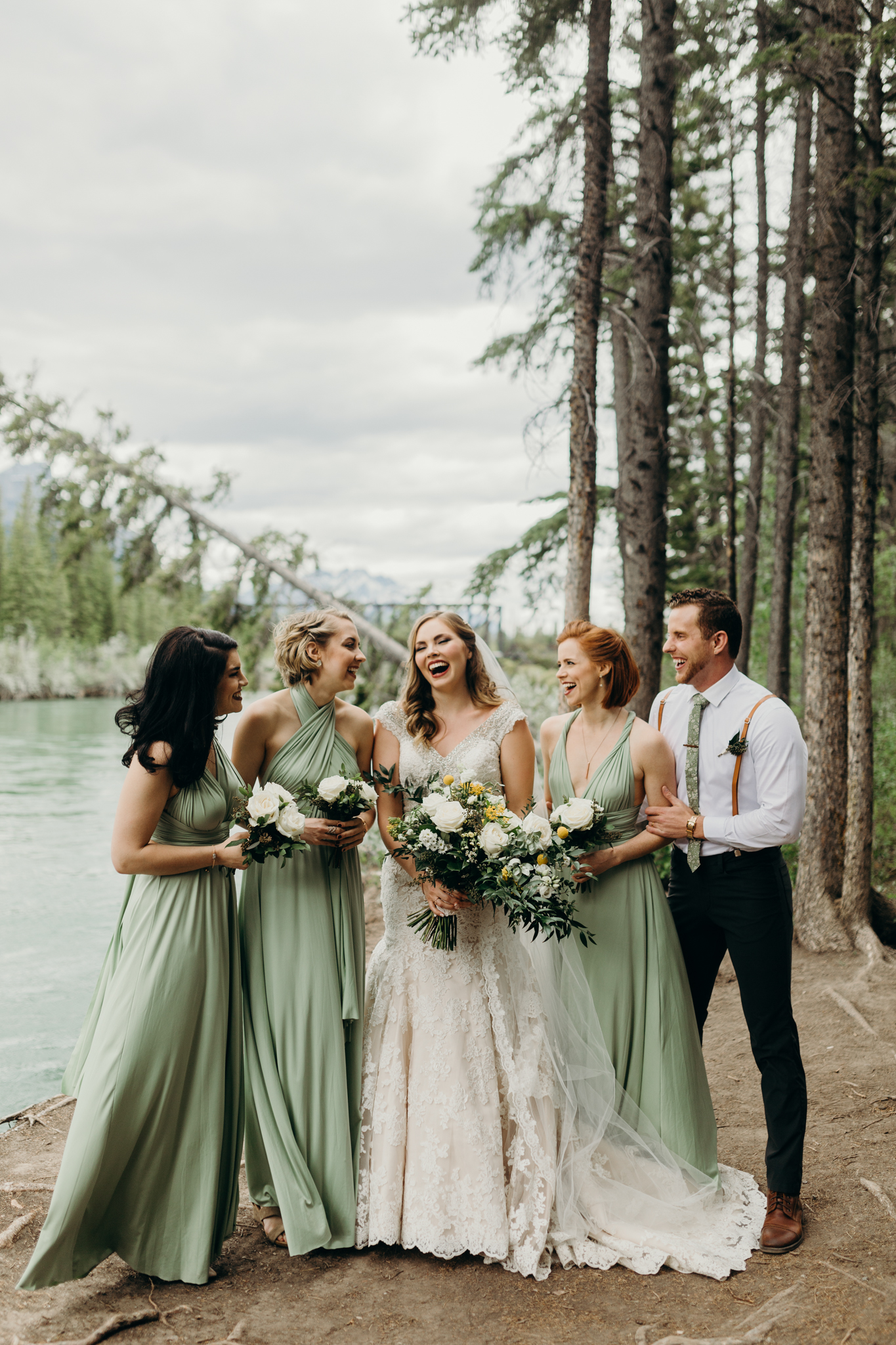 Brides and bridesmaids portrait at Bow River Canmore destination wedding