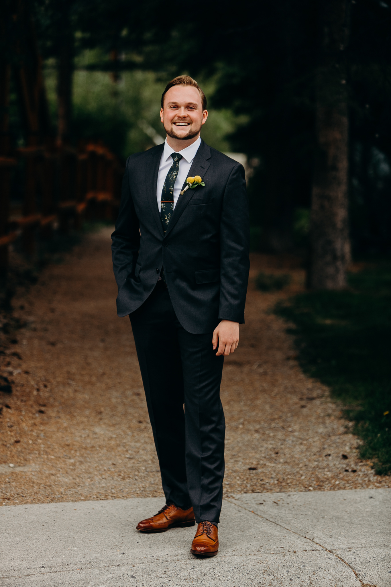 Portrait of smiling groom in suit and tie outdoors destination wedding canmore